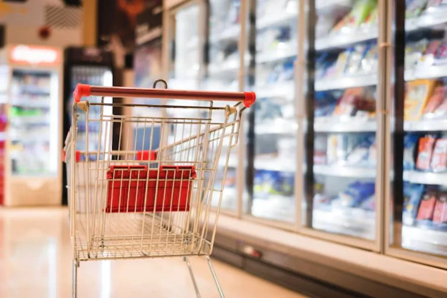 Shopping trolley in a supermarket aisle